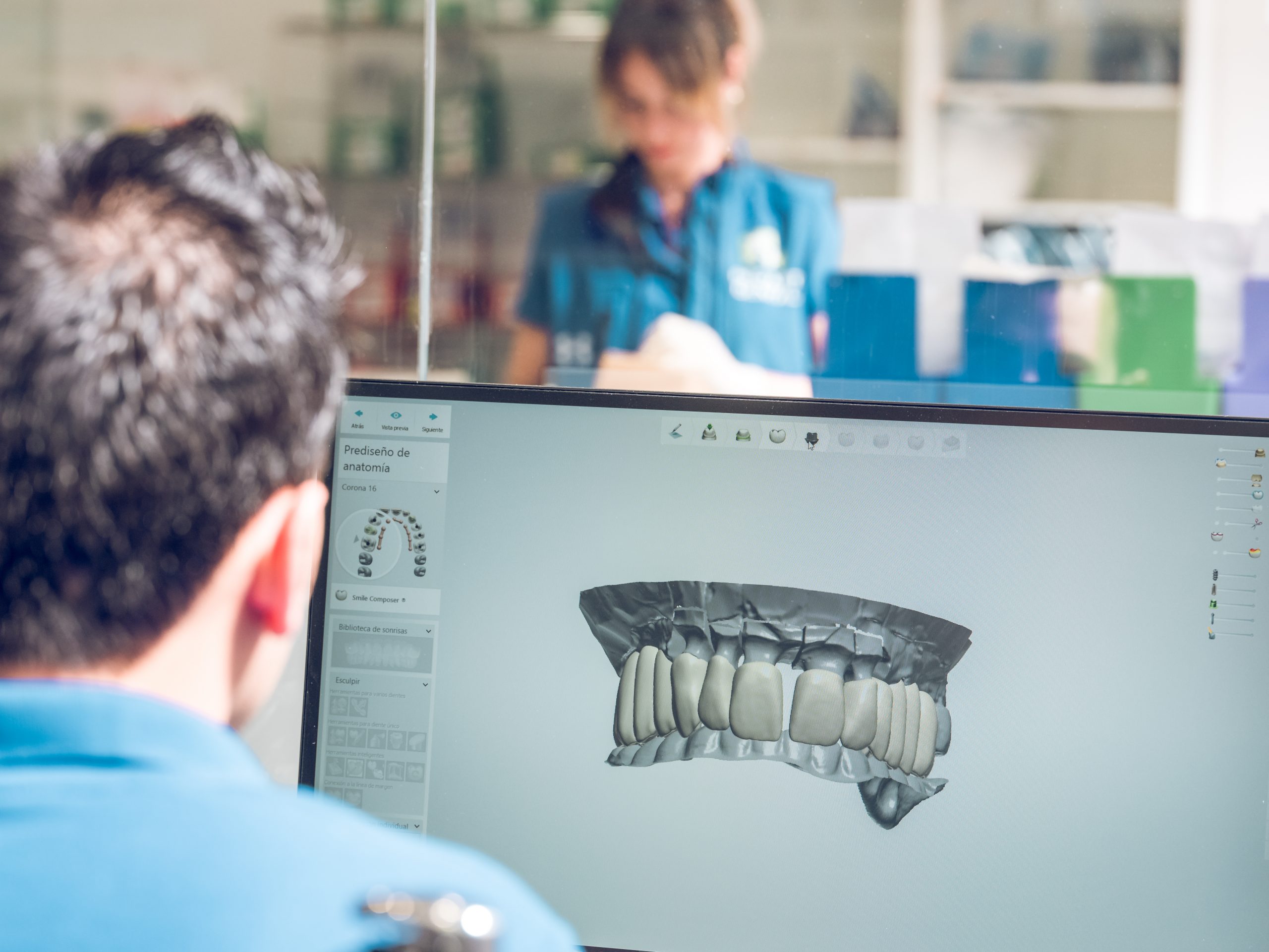 Dentist looking at 3D rendering of upper tooth arch on a computer.